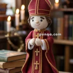 A crocheted doll dressed in a red and gold bishop's outfit, featuring intricate stitching and a mitre. The doll stands on a wooden table in a room lit by candles, with bookshelves in the background.