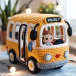 A crocheted toy bus labeled "Route 7" with a small doll inside, placed on a table with string lights in the background.