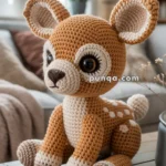 Crocheted deer plush toy with large eyes and spots, sitting on a wooden table in a cozy room.