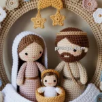 A crocheted wreath featuring a nativity scene with figures representing Mary, Joseph, and baby Jesus, surrounded by decorative flowers and stars.