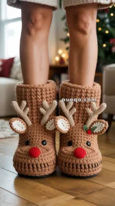 Person wearing knit reindeer slippers with red noses and antlers, standing on a wooden floor.